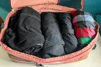 An opened piece from the Blast 6PCS Compression Travel Packing Cubes packed with clothing