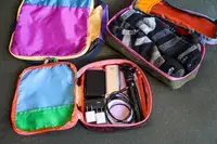 Two opened filled Cotopaxi Cubos Packing Cubes