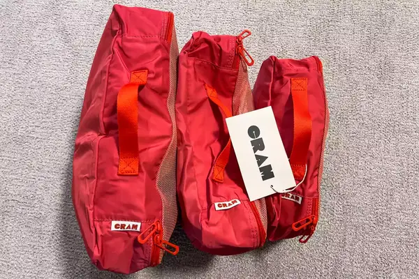 The Cram Packing Cubes with tags standing on a floor