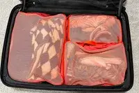 The Cram Packing Cubes packed in a suitcase