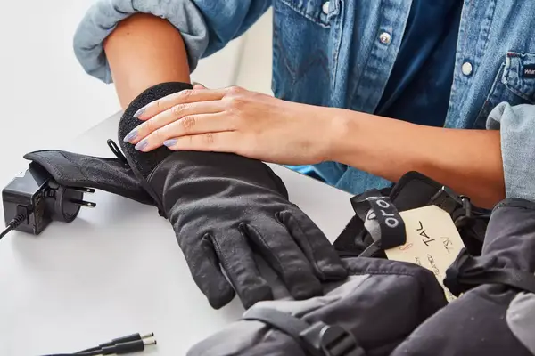 A person wears the Gerbing 7V Hard Knuckle Battery Heated Gloves