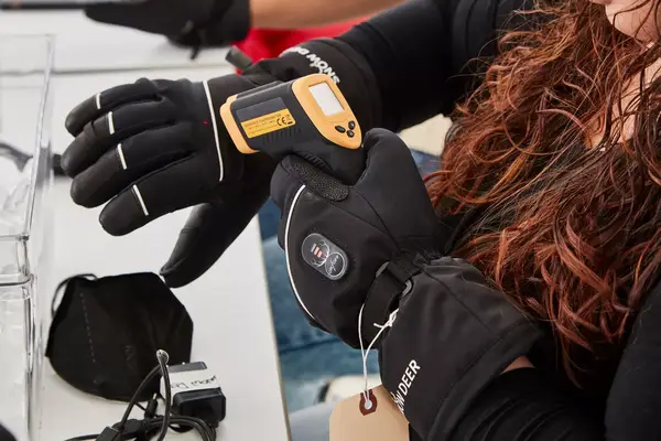 A close-up of the power button on the DAY WOLF Rechargeable electric gloves