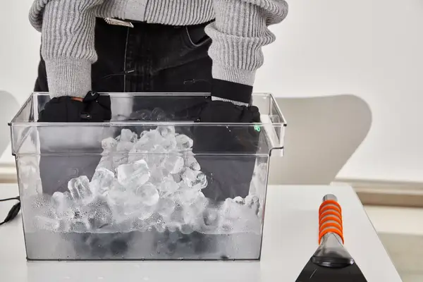 DAY WOLF Rechargeable electric gloves on a wooden floor with a charging adapter