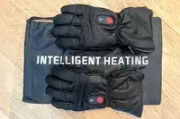 The DAY WOLF Rechargeable electric gloves on top of their storage pouch