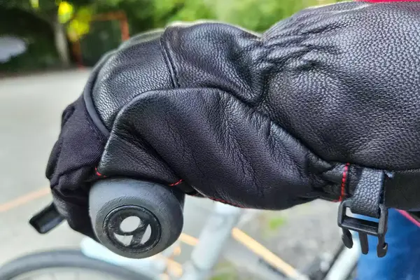 A person wears the Gerbing 7V Hard Knuckle Battery Heated Gloves