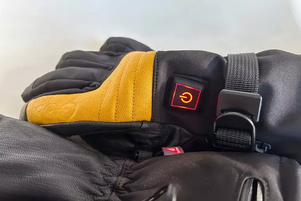 A close-up of the power button on the Gobi Heat ​​Vertex II Heated Ski Gloves