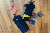 The Gobi Heat ​​Vertex II Heated Ski Gloves with storage pouch and accessories