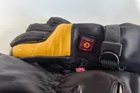 A close-up of the power button on the Gobi Heat ​​Vertex II Heated Ski Gloves