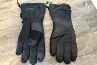 The Outdoor Research Prevail Heated GORE-TEX Gloves on a wooden floor