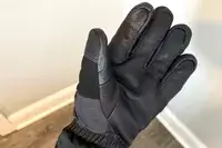 A person wears the Outdoor Research Prevail Heated GORE-TEX Gloves