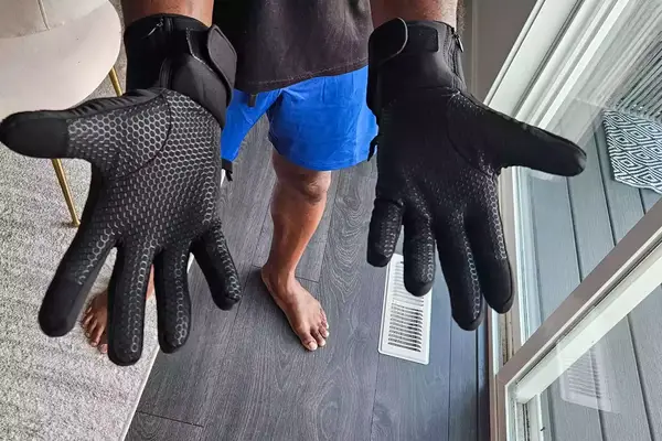 A person wears the SAVIOR HEAT Heated Glove Liners inside