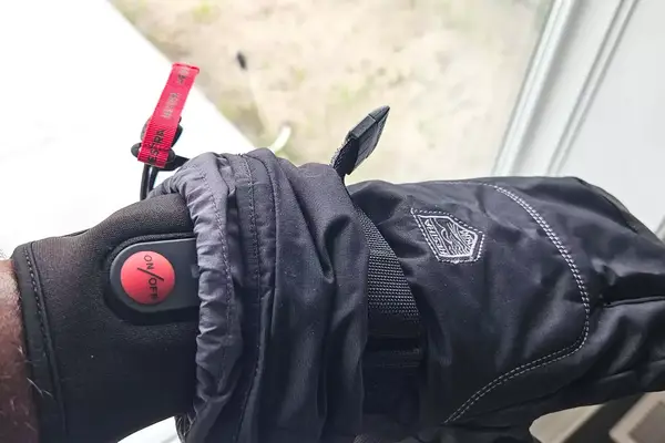 A close-up of the power button on the SAVIOR HEAT Heated Glove Liners