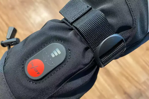 A close-up of the power button on the Snow Deer Heated Mittens