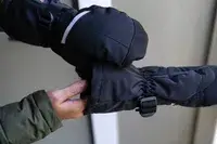 A person wears the Snow Deer Heated Mittens