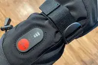 A close-up of the power button on the Snow Deer Heated Mittens