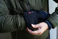 A person wears the Snow Deer Heated Mittens