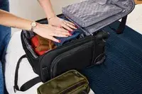 A person packs travel items in the Samsonite Theorym Underseater