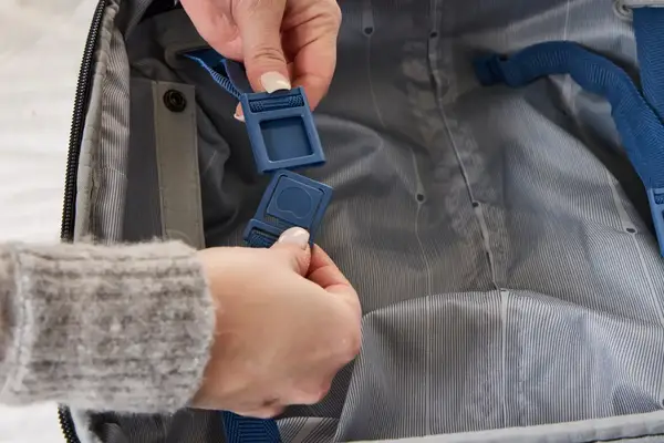 A person secures the snaps on the Delsey Paris Cruise 3.0 2-Wheeled Underseater