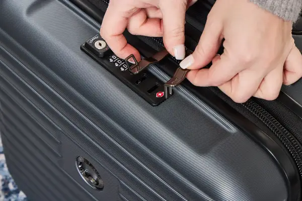 A person unlocks the Delsey Paris Cruise 3.0 2-Wheeled Underseater