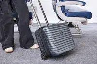 A person wheels the Delsey Paris Cruise 3.0 2-Wheeled Underseater over carpet