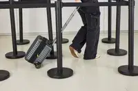 A person wheels the Delsey Paris Cruise 3.0 2-Wheeled Underseater over linoleum