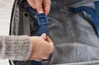 A person secures the snaps on the Delsey Paris Cruise 3.0 2-Wheeled Underseater