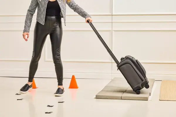 A person wheels the Hartmann Herringbone Deluxe Underseater over stone