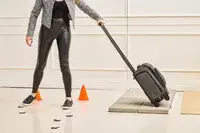 A person wheels the Hartmann Herringbone Deluxe Underseater over stone