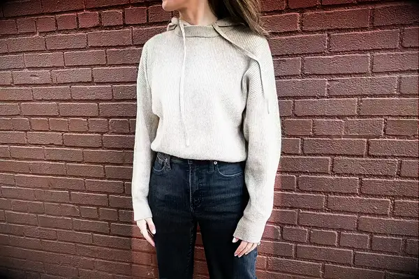 A woman wearing the Lilysilk Eshe 2-in-1 Cashmere Detachable Hoodie