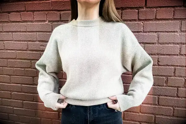 A woman wearing the Lilysilk Eshe 2-in-1 Cashmere Detachable Hoodie without the hoodie