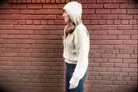 A woman wearing the Lilysilk Eshe 2-in-1 Cashmere Detachable Hoodie with the hood up