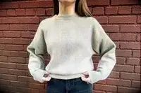 A woman wearing the Lilysilk Eshe 2-in-1 Cashmere Detachable Hoodie without the hoodie