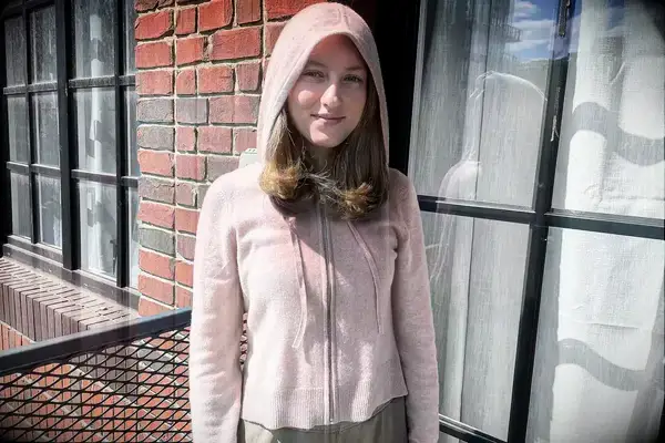 A person wearing the Naadam Signature Cashmere Cropped Zip-up Hoodie