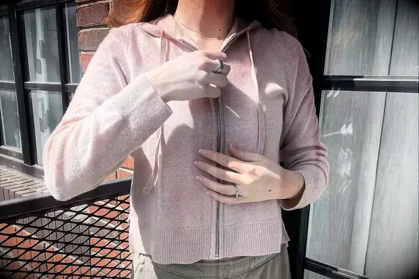 A person wearing the Naadam Signature Cashmere Cropped Zip-up Hoodie