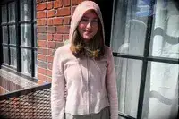 A person wearing the Naadam Signature Cashmere Cropped Zip-up Hoodie