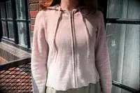 A person wearing the Naadam Signature Cashmere Cropped Zip-up Hoodie