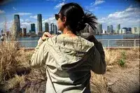 the back of a woman wearing the Hikerkind Trail Sun Hoodie 01