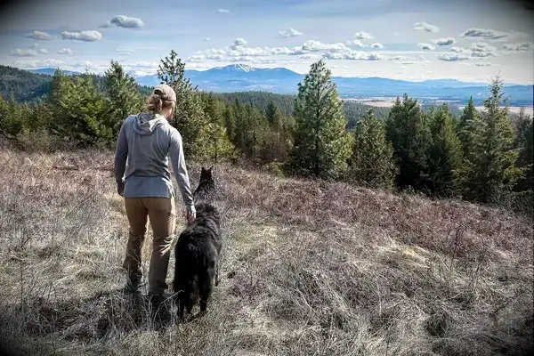 A person next to a dog wearing the Outdoor Research Women