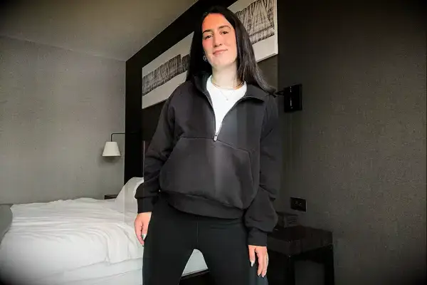 A person wearing the Athleta Easy Fleece Half Zip Hoodie