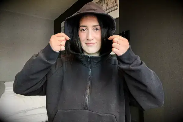 A person wearing the Athleta Easy Fleece Half Zip Hoodie