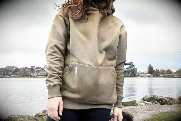 A person standing next to a body of water wearing the Portland Gear Cloudburst Hoodie