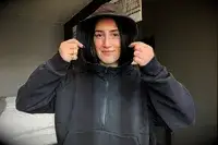 A person wearing the Athleta Easy Fleece Half Zip Hoodie