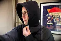 A person wearing the Athleta Easy Fleece Half Zip Hoodie