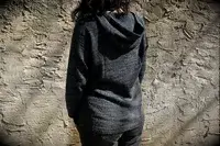 A person wearing Paka The Hoodie