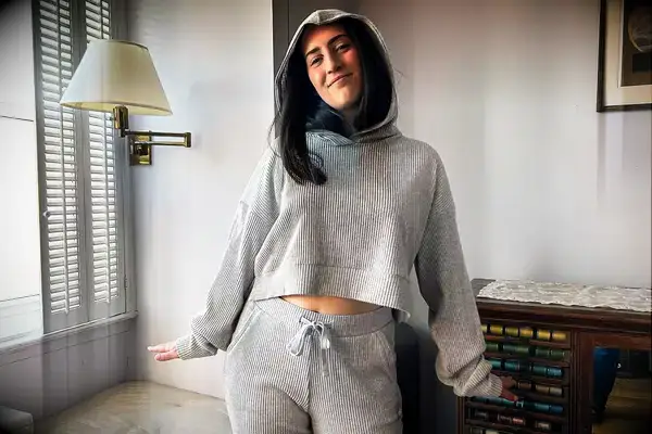 A person wearing the Alo Muse Hoodie