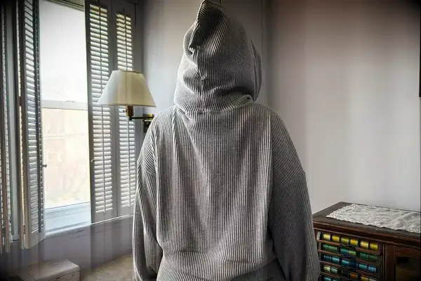 A person turned around wearing the Alo Muse Hoodie