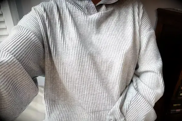 A person wearing the Alo Muse Hoodie