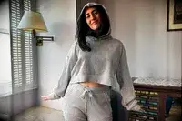 A person wearing the Alo Muse Hoodie