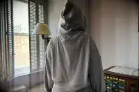 A person turned around wearing the Alo Muse Hoodie