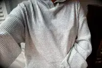 A person wearing the Alo Muse Hoodie